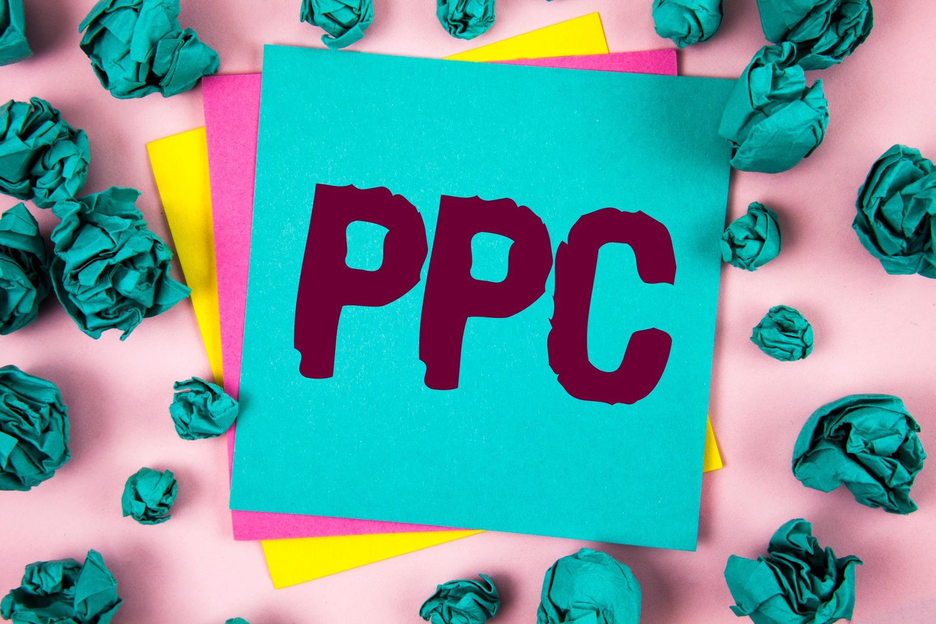 Handwriting text Ppc. Concept meaning Pay Per Click Advertising Strategies Direct Traffic to Websites written on Sticky Note Paper on plain background Crumpled Paper Balls next to it.